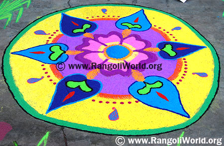 Freehand Rangoli with yellow color filling and pink flower in the middle