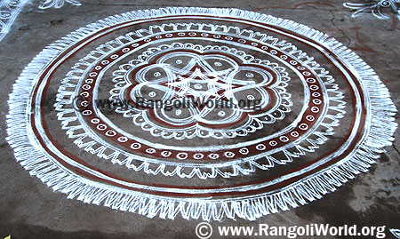 Two stroke Freehand Rangoli with white and maroon color pooja circle